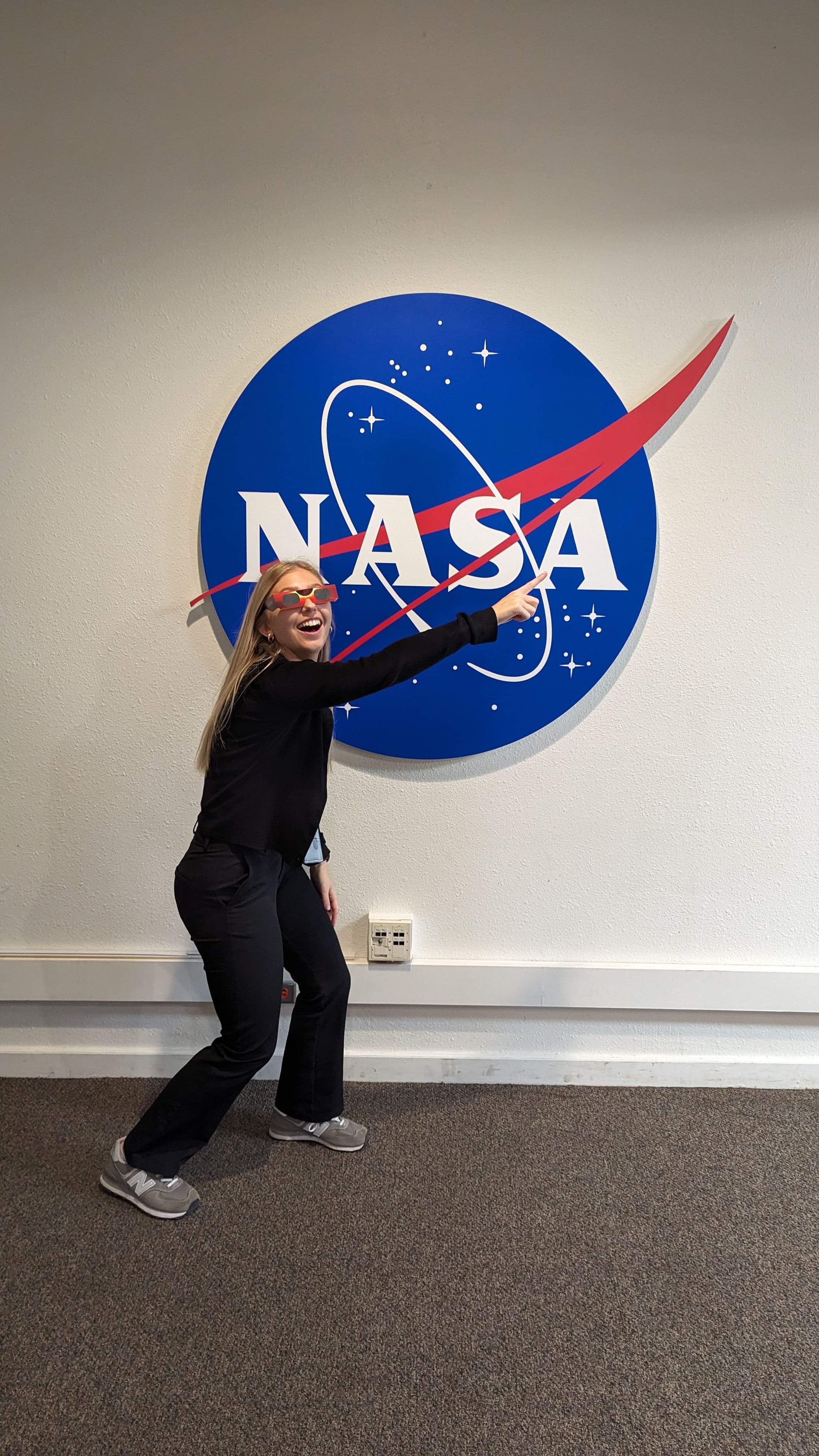 Blonde girl in front of NASA logo
